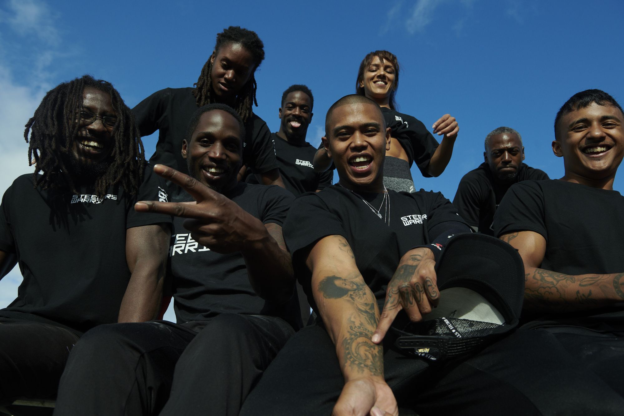 The Steel Warriors crew in team t-shirts against a blue sky